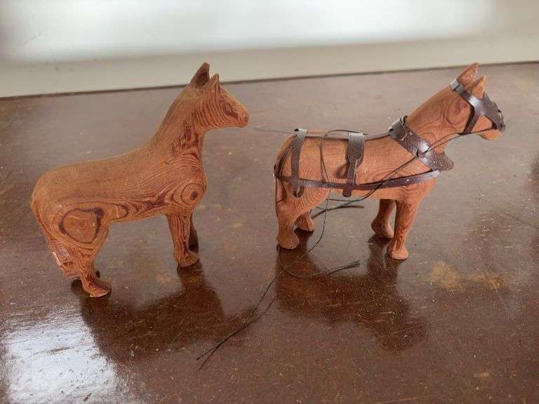 2 hand carved horses
