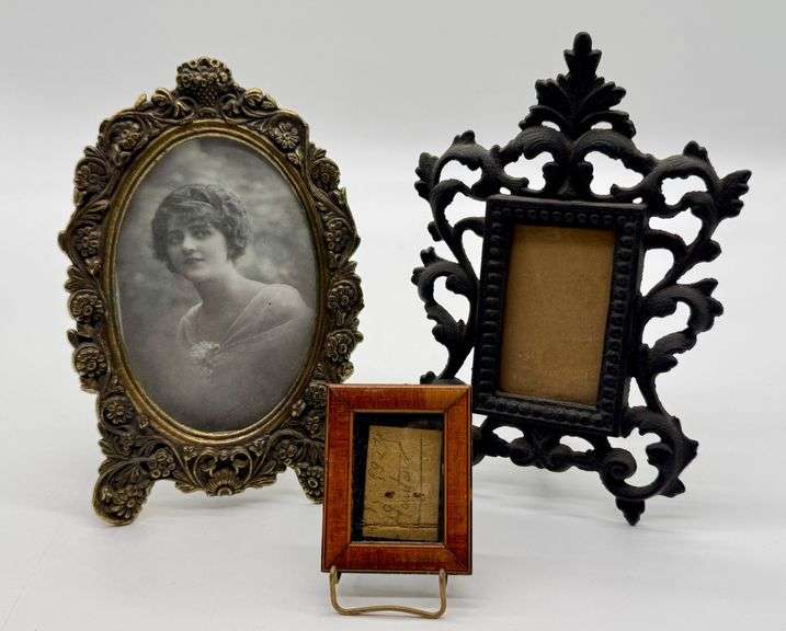 Three Decorative Tabletop Picture Frames, Including Ornate Brass, Cast Iron, and Wood