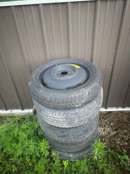 4 Wheels and Spare, Including Five Used Tires, One Aluminum Wheel with Powertrac Tire, and One Spare