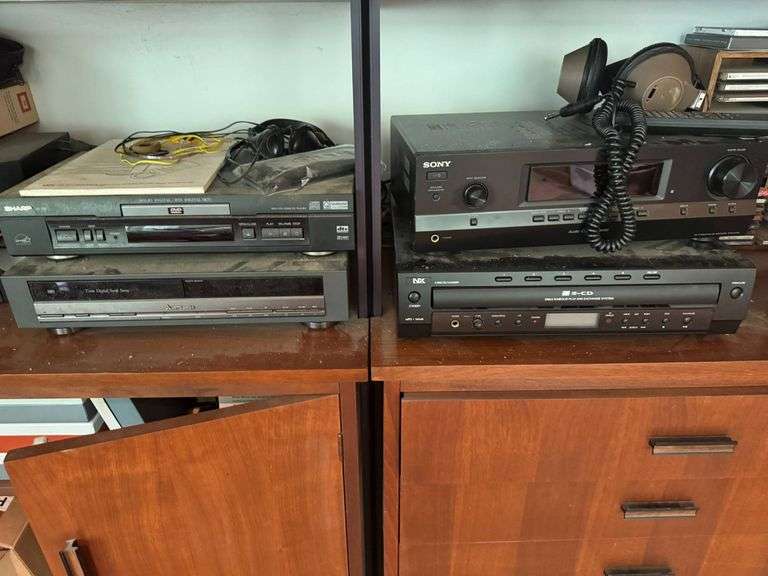 Vintage Electronic Audio Equipment Including a Sony Receiver and Sharp VHS/DVD Player