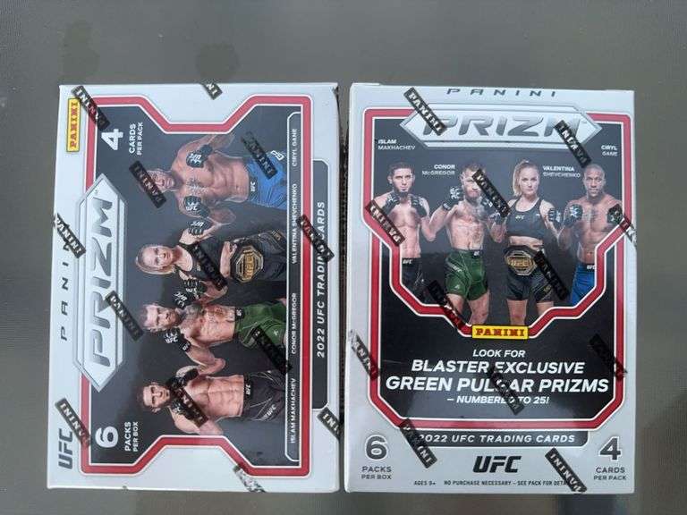 Two sealed boxes of UFC Panini prizm trading cards.