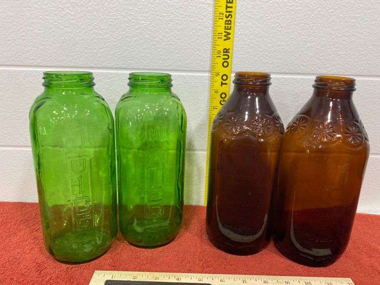 Four Glass Bottles in Green and Amber Colors - Auction Ohio