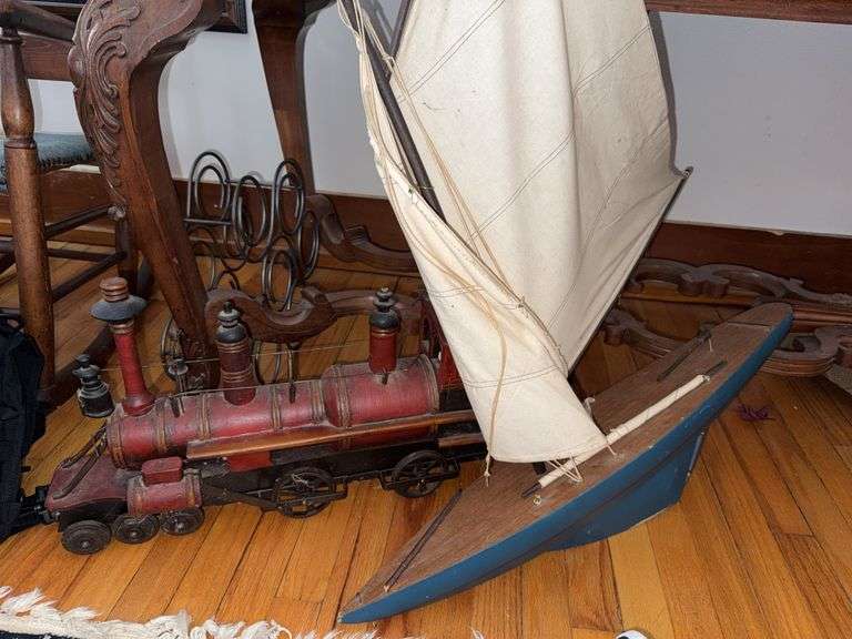 Wooden Sailboat Model and Painted Metal Locomotive Model