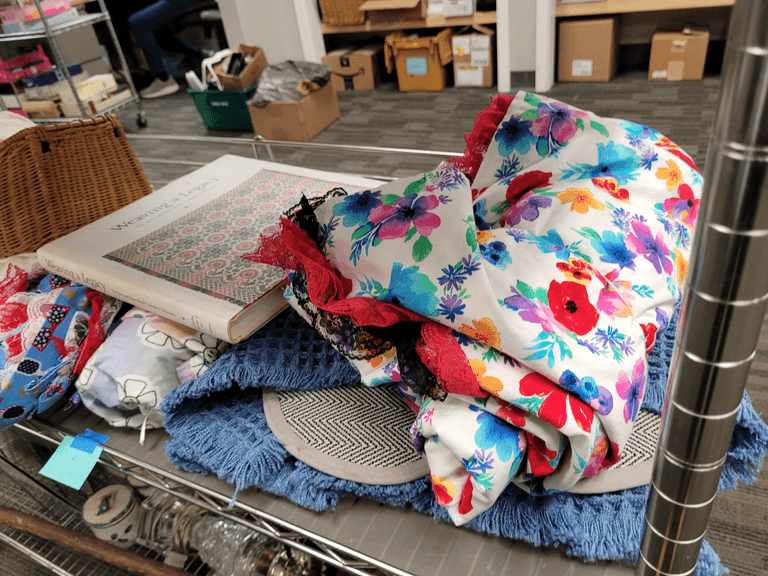 Mixed Textile & Book Shelf Lot – Vintage Linens, Fabric, Wicker Basket, “Weaving a Legacy” & More