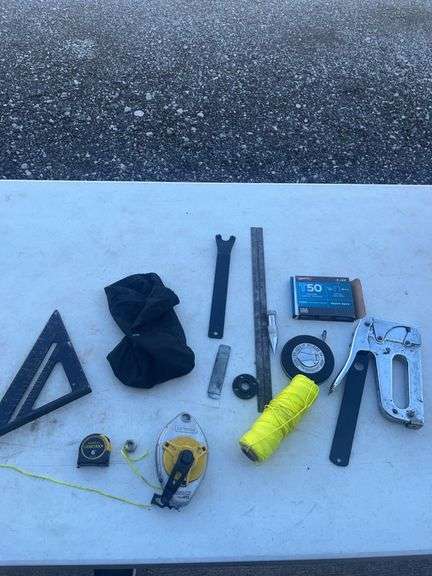 Hand Tools and Supplies Including Square, Tape Measure, Staple Gun, and Chalk Line
