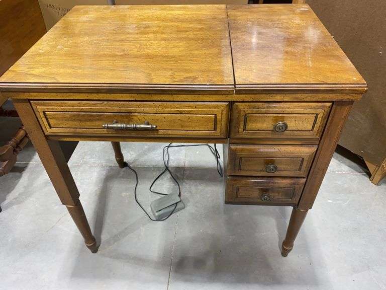 Vintage electric sewing machine with an integrated wooden cabinet