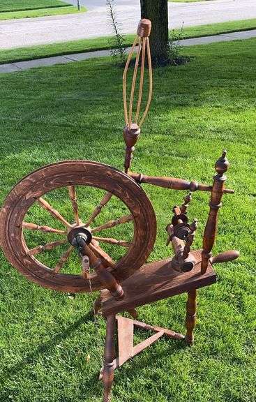 An antique 19th-century Saxony-style wooden spinning wheel