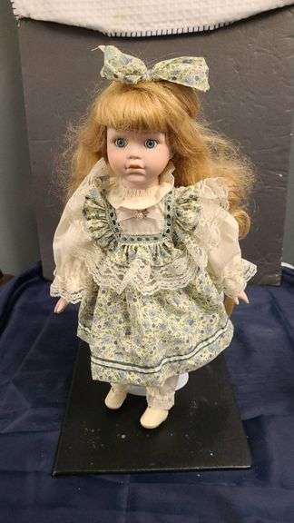 Porcelain Doll with Blue Eyes in Floral Dress and Bow