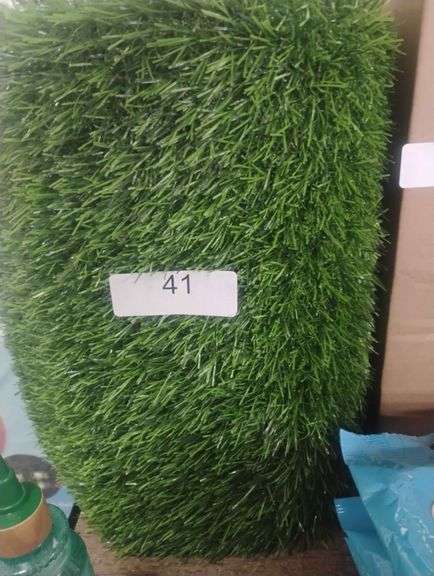 Artificial Grass Turf. A synthetic mat designed to replicate the appearance and feel of natural grass for landscaping or decorative purposes. - N/A