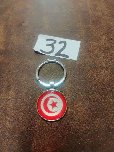 Tunisia Flag National Emblem Metal Keychain. This metal keychain features a round charm displaying the national flag of Tunisia, ideal for holding keys or as a decorative accessory. - $9.00