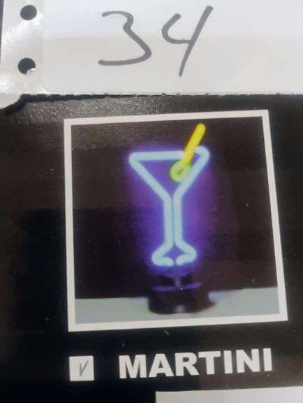 Martini Neon Sign. A decorative neon sign featuring a martini glass shape with an olive, perfect for adding ambiance to a bar or entertainment area. - $60.00