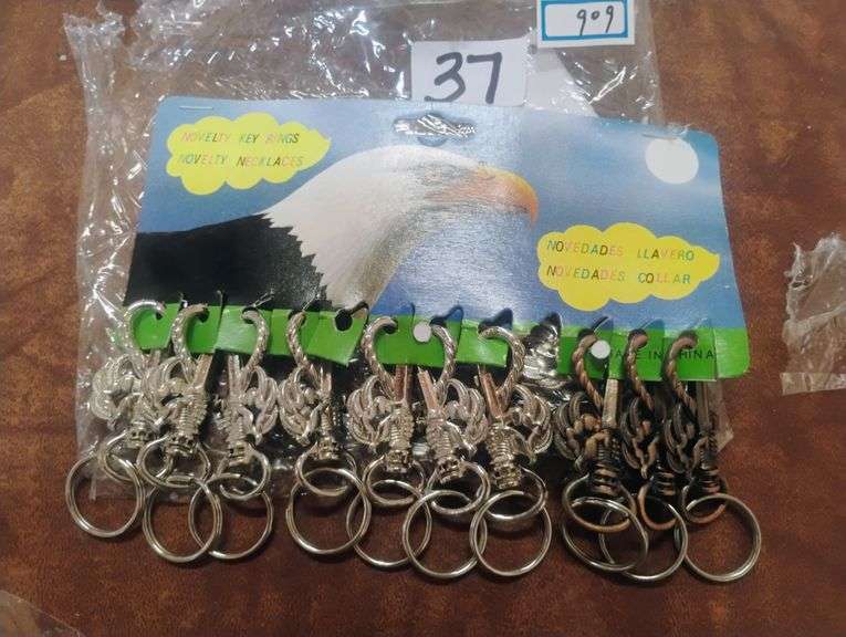 Novelty Eagle Head Key Ring Set. This set features multiple key rings, each adorned with an eagle head design in various metallic finishes, suitable for holding keys or as decorative items. - $15.00