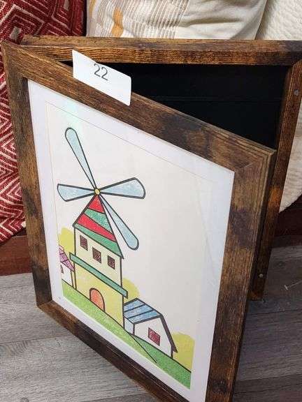 HANDCRAFTED WOODEN SHADOW BOX FEATURING A CHILD'S DRAWING OF A WINDMILL. 
IT HAS A RUSTIC WOODEN FRAME AND A HINGED FRONT PANEL
