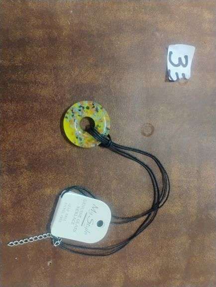 My Style Yellow Flecked Genuine Glass  Pendant Necklace. This necklace features a round, donut-shaped yellow glass pendant with multicolored flecks, suspended on a black cord with an adjustable extender chain. - $15.00