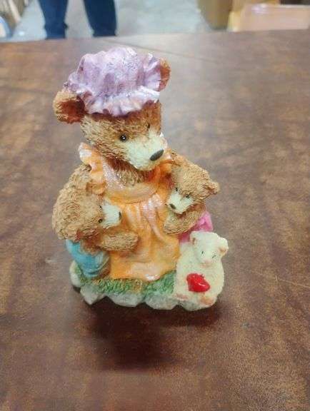 Mother Bear and Cubs Resin Figurine. This decorative resin figurine depicts a mother bear wearing an apron and bonnet, embracing two bear cubs, with a small lamb holding a heart at her feet. - $25.00