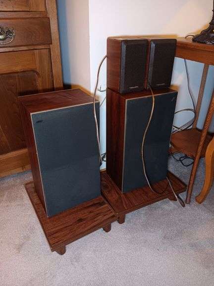 (2) Beovox S45 Speakers, (2) Realistic Small Speakers, and (2) Wooden Speaker Stands