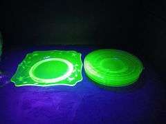 Uranium/Vaseline Glass: Goblet, Floral Platter Plate, and (6) Saucer Plates