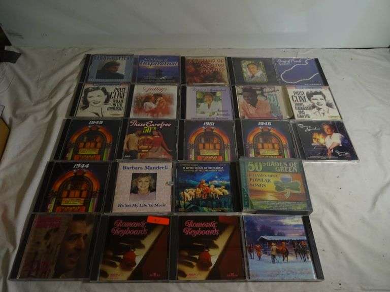 Assorted CDs such as Patsy Cline Fifty Shades of Green 1951 54 1949 jukebox Classics and more
