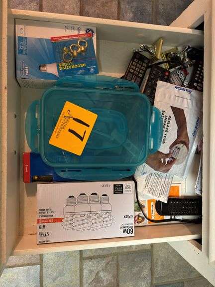 Lot of light bulbs and remote controls. Drawer not included.