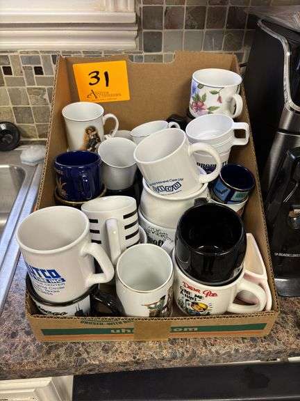 Lot of assorted coffee mugs.