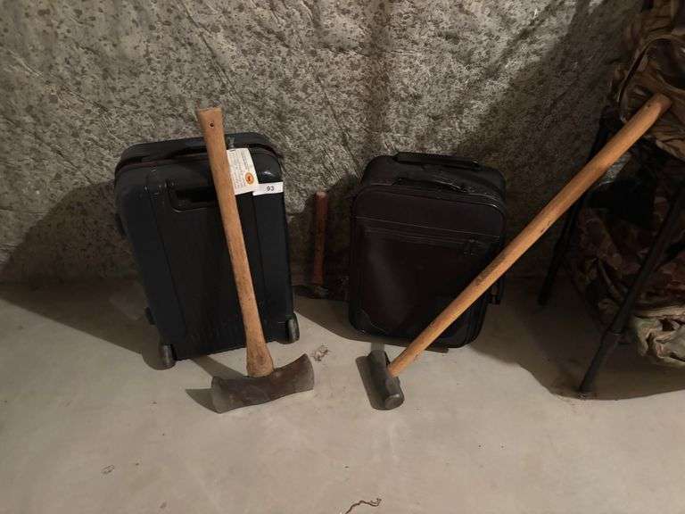 2 suitcases with sledge hammers axes