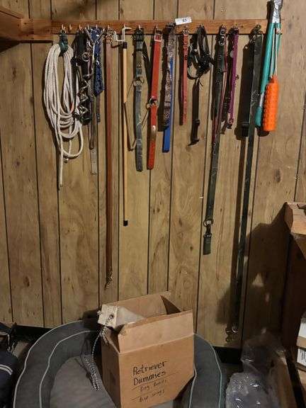 Dog bed with retriever dummies, dog leashes