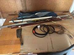 Table with chair, rulers, machete extended cords apron