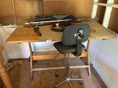 Table with chair, rulers, machete extended cords apron