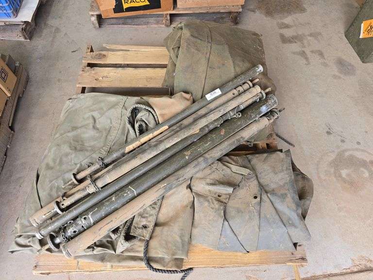 Military Tents w/ Some Poles w/ Poles Missing.