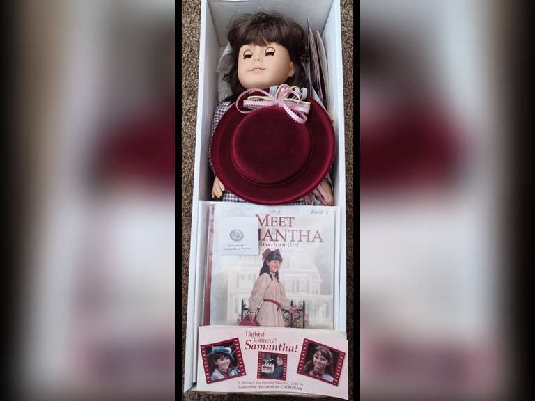 Samantha Parkington. Samantha is one of Pleasant Company’s first-four original American Girl Dolls. She stands 18 inches tall and wears her original period clothing. She made her debut in 1986. At the turn of the 20th century, she is an orphan and goes to live with her grandmother in upstate New York. Jip, her dog accompanies Samantha. She has been maintained exclusively for display purposes behind glass in a smoke-free environment and she has not been used for play.
Samantha comes complete with all her accessories including “Jip”, along with the book, “Meet Samantha” in her original box. Her doll stand is packed separately.