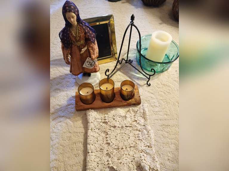 Greek porcelain doll, candles, lace runner, photo frame