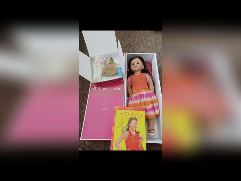 Jess McConnell. Jess is an original American Girl Doll. She was released in 2006 and is the fourth Girl of the Year doll. She stands 18 inches tall and wears her original period clothing. Her time-period is early 2000s when she accompanies her archaeologist parents on a dig to Belize. Jess has been displayed exclusively behind glass in a smoke-free environment, and she has not been used for play.
Jess comes with all her accessories, including doll stand and her book, “Jesse”, in the original box.