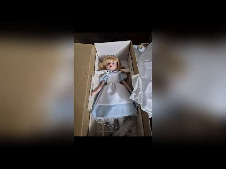 THE DISNEY COLLECTION
Alice In Wonderland
This like “NEW” in box doll is a 1988 Vintage doll manufactured by Grolier Enterprises. Alice stands 18 inches tall and comes with her stand. She is of fine porcelain quality. Alice has been displayed behind glass in a smoke-free environment, and she has never been used for play.