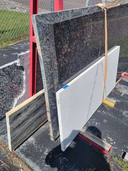 Four Stone Pieces Featuring Various Patterns