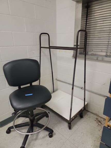 Black office chair and rolling rack