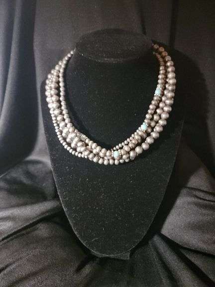 Multiple strands of silver and turquoise colored beads