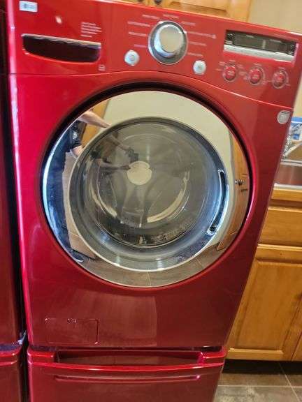 Red LG front loading washing machine with stand, very nice condition