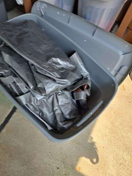 Tote with tarps and extension cords.