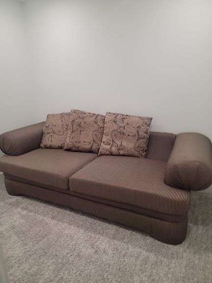 Two Brown striped sofa & Throw pillows in basement