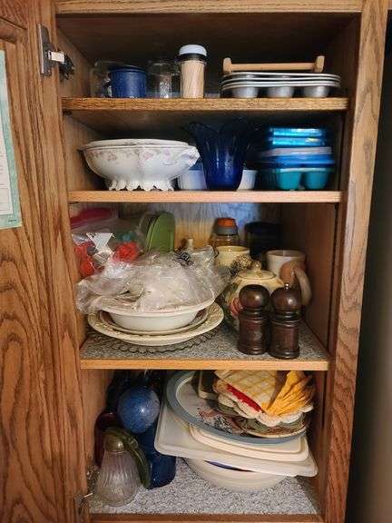 Contents of Four Shelves in Cabinet: Salt & Pepper Shakers, Ice Cube Trays, Muffin Pans, Pot Holders, Lids, Ceramic Teapots