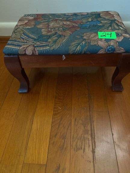 Cherry wood footstool with floral cushioned top.