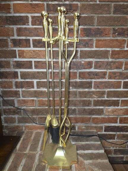 Golden colored fireplace tool set with stand