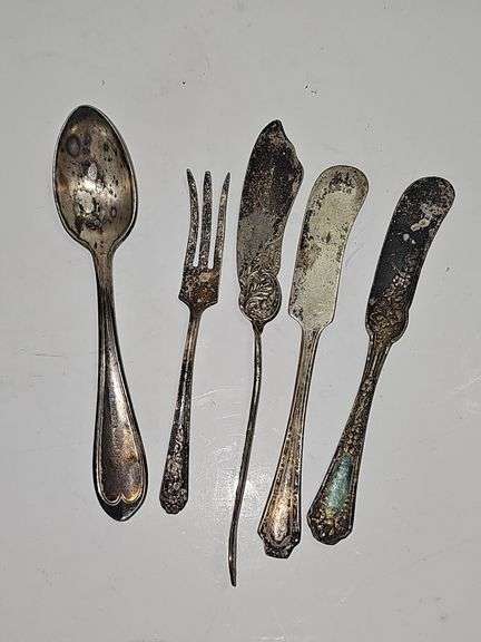 Silver colored cup and flatware