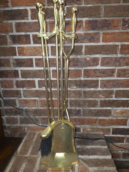 Golden colored fireplace tool set with stand