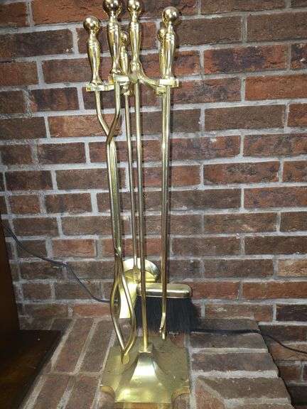 Golden colored fireplace tool set with stand