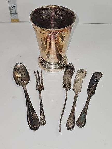 Silver colored cup and flatware
