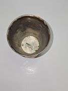 Silver colored cup and flatware