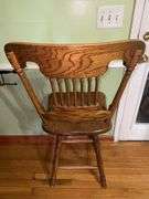Vintage solid wood swivel bar stool.