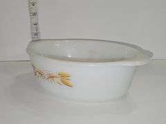 Fire-King casserole dish with the "Golden Wheat" pattern.