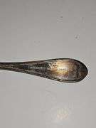 Silver colored cup and flatware